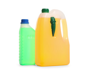 Plastic canisters with different liquids for car on white background