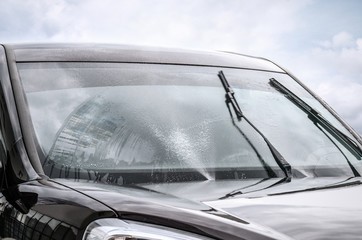 Washing car windscreen with wipers and liquid, closeup - obrazy, fototapety, plakaty