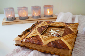 photo album on the table and candles. the cloth. background.