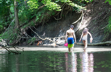 Boy & Girl walking in river