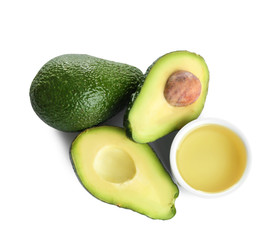 Bowl of natural oil and avocados isolated on white, top view