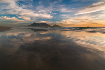 Cape Town beach sunset with Table Mountain in the distance