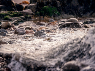 Water in a stream, selective focus, abstract nature background.
