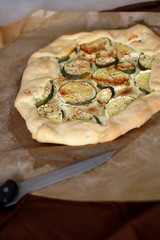 Homemade galette with zucchini and feta cheese. Selective focus.