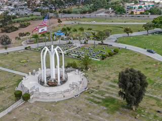 Aerial view of Greenwood Memorial Park & Mortuary. Memorial statue with American flag. Funeral,...