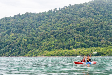 Two woman tourists are mother and daughter. Travel by boat with a kayak happy on the sea in the morning of summer at Ko Adang island is the background, Tarutao National Park, Satun, Thailand