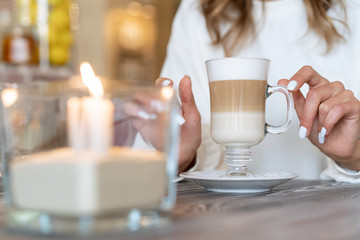 coffee latte on table with candles. Romantic mood.