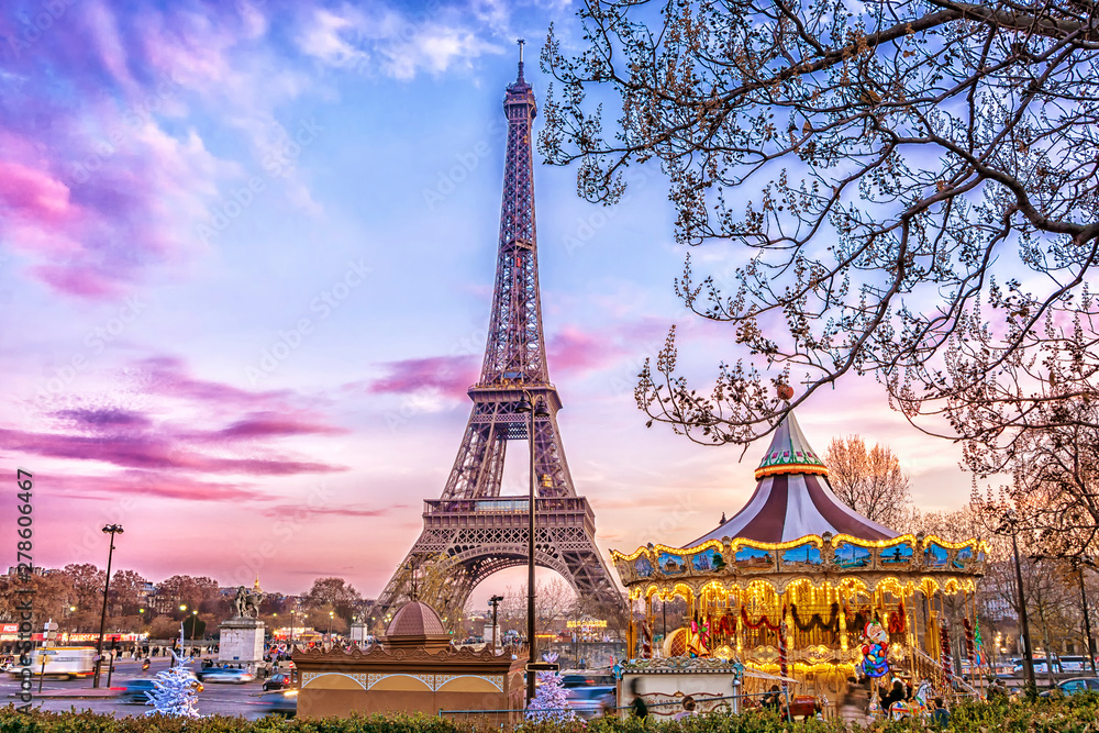 Wall mural the eiffel tower and vintage carousel on a winter evening in paris, france.