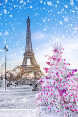 Eiffel Tower is the main attraction of Paris on the background of  Christmas trees covered by snow in winter. Travel Greeting Card from Paris with love, France
