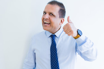 Middle age man doing postive gesture with thumbs up smiling to the camera