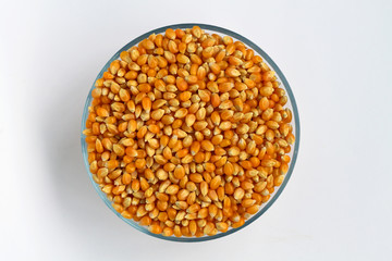 yellow corn in a bowl isolated on white background