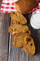 Freshness homemade bread with cup of milk on wooden background. Healthy organic food concept
