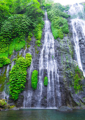 Banyumala waterfall with cascades among the green tropical trees and plants in the North of the island of Bali, Indonesia