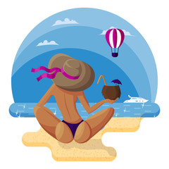 Beautiful woman in a hat sits on the sandy beach with her back to the viewer with a coconut cocktail
