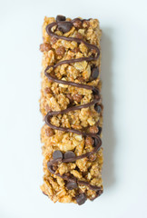 Granola bar with cereal and chocolate on a white background.