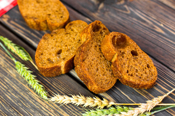Freshness homemade bread with cup of milk on wooden background. Healthy organic food concept