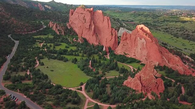 Aerial, tracking, drone shot, panning around sandstone mountains, at the Garden of the Gods, on a sunny evening, in Colorado springs, USA