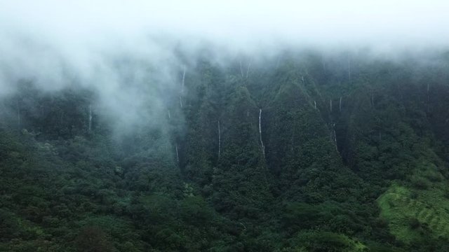 Cinematic Aerial of Clouds and Waterfalls After Heavy Rainfall at Bottom of Haiku Stairs Known as Stairway To Heaven on Oahu Island, Hawaii