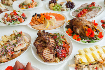 Beautiful festive table served for wedding celebration dinner at home or restaurant interior. Table full of food at a restaurant.  Full round table.