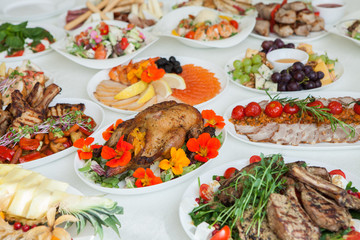 Beautiful festive table served for wedding celebration dinner at home or restaurant interior. Table full of food at a restaurant.  Full round table.