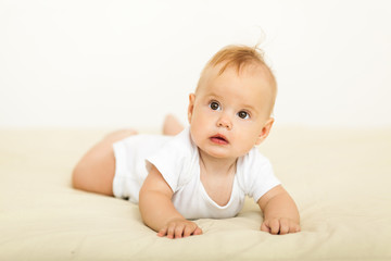 Portrait of happy smile baby relaxing on the bed