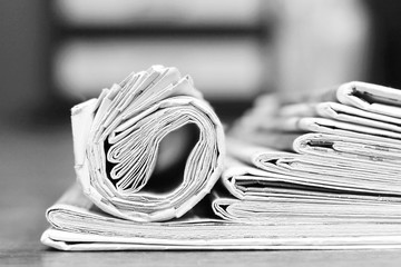 Newspapers and Magazines. Pages with News Folded adn Rolled and Stacked in Pile. Tabloid Journals with Headlines and Articles