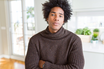 African American man wearing winter sweater Relaxed with serious expression on face. Simple and natural with crossed arms