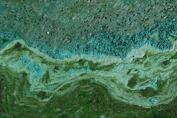 Naklejka premium Cropped shot of dirty water, top view. Ecology, environmental pollution, nature concept. Abstract colorful background texture.