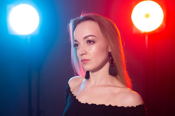 Portrait of young sexy woman with flashes on background