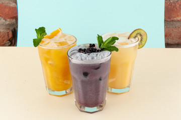 Refreshing fling cocktails with fruit juices, sorbet and soda: blueberry cocktail, orange cocktail and exotic one