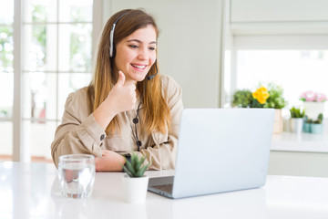 Beautiful young operator woman working with laptop and wearing headseat happy with big smile doing...