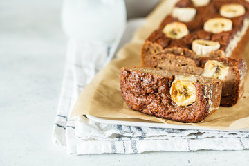 Homemade sliced banana bread on a white background, copy space.