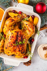 Christmas baked chicken with cranberries, orange, spices and herbs. Christmas food concept.
