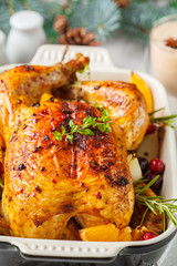 Christmas baked chicken with cranberries, orange, spices and herbs. Christmas food concept.