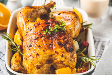 Christmas roasted chicken with cranberries, orange, spices and herbs. Christmas food concept.