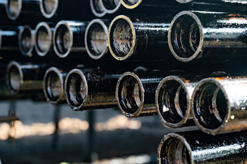 Drillpipe on Oil Rig Pipe Deck. Oil and gas industry. Work of oil pump jack on a oil field.