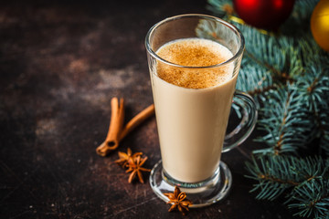 Christmas eggnog in a glass in Christmas background, copy space.