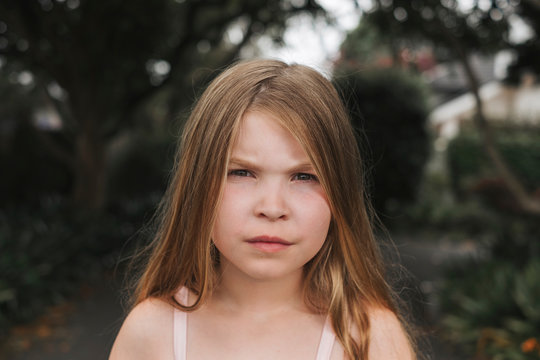 Young girl with a serious face looking forward