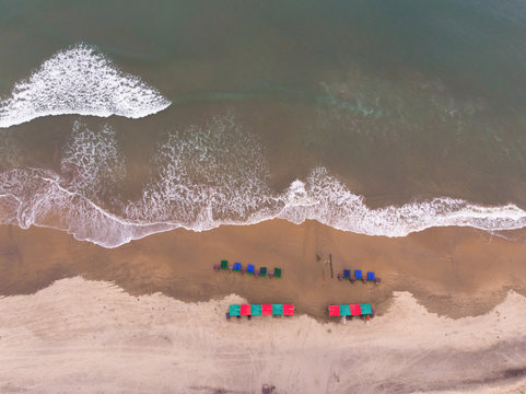 Top down aerial view of waves on mandrem beach in Goa state of India.