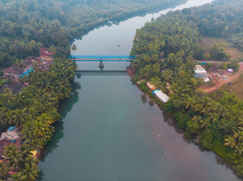 Aerial view of Sadolxem bridge over Talpon river with a boat in Canacona , South Goa, India.