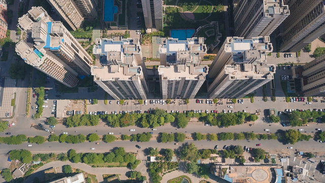 Top down aerial view of multistoreys buildings of ATS society by the main road in day light, Indrapuram, Delhi ncr, India.