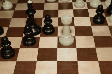 Wooden chessboard with white chessmen as a game background