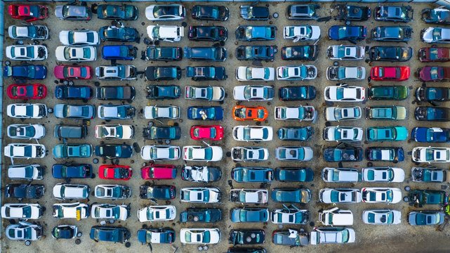 Aerial view of rows of old cars that have served, assembled in a junk yard waiting to be recycled for their reusable parts, Aurora, IL, USA.