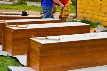 Workers assemble new wooden cabinets furniture in the street