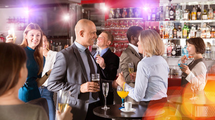 Man talking to woman on corporate party