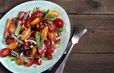  cherry tomatoes salad of different colors and basil. bright summer salad. 