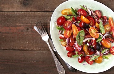  cherry tomatoes salad of different colors and basil. bright summer salad. 