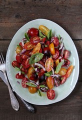  cherry tomatoes salad of different colors and basil. bright summer salad. 