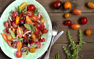  cherry tomatoes salad of different colors and basil. bright summer salad. 