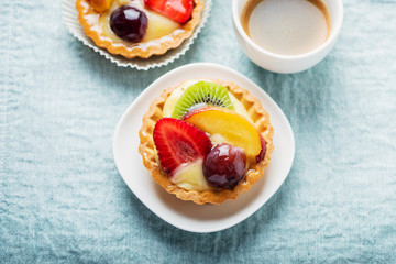 Mini tarts with cream and mix of summer fruit